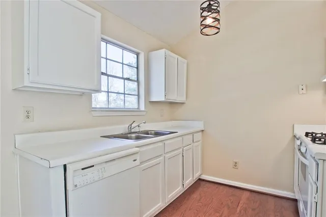 a kitchen with a sink cabinets and a window