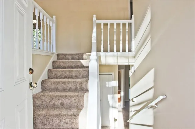 a view of staircase with white walls and windows