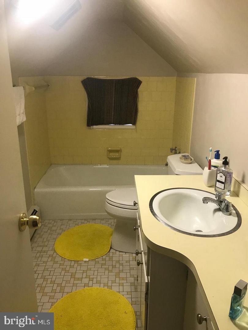 112 Fairview Avenue Frederick, MD 21701 - Photo 11 of 24 a bathroom with a sink a toilet and a mirror