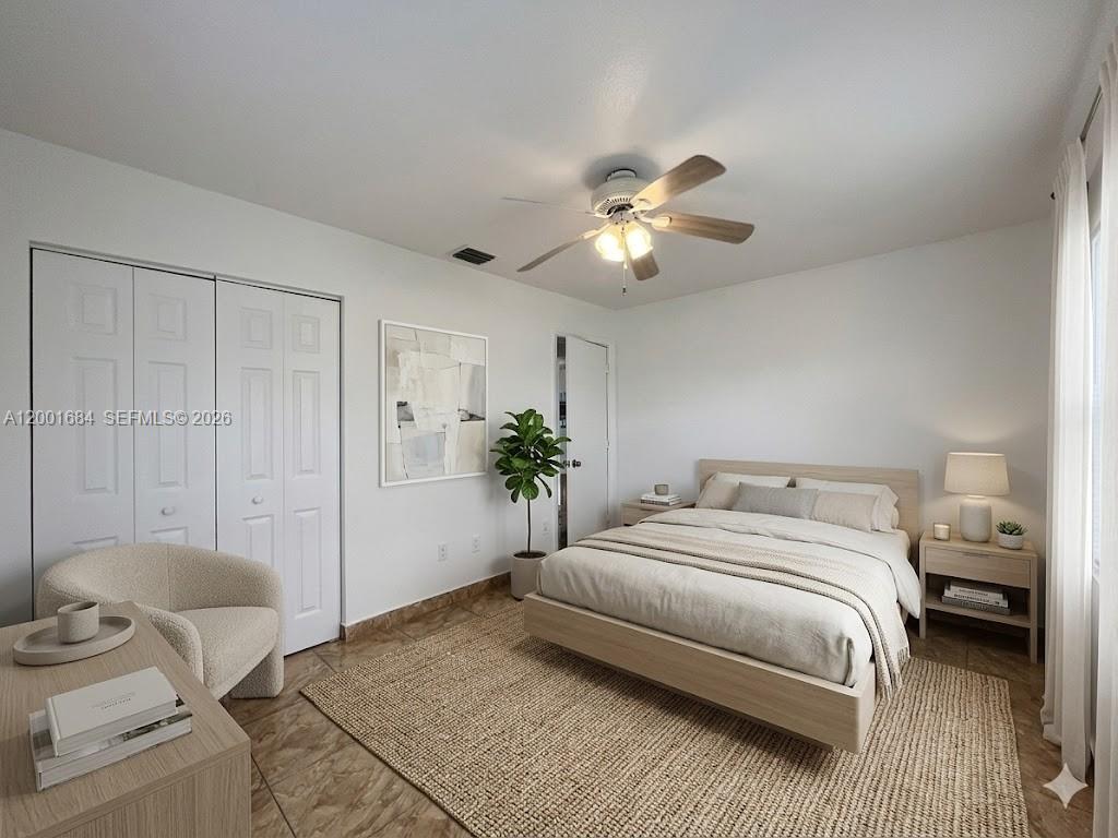 620 84th Street, Unit 25 Miami Beach, FL 33141 - Photo 12 of 12 a bedroom with a bed and a chandelier
