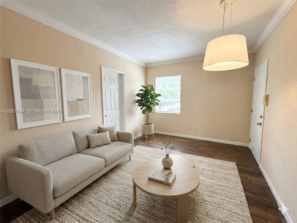 620 84th Street, Unit 25 Miami Beach, FL 33141 - Photo 2 of 12 a living room with furniture and a wooden floor