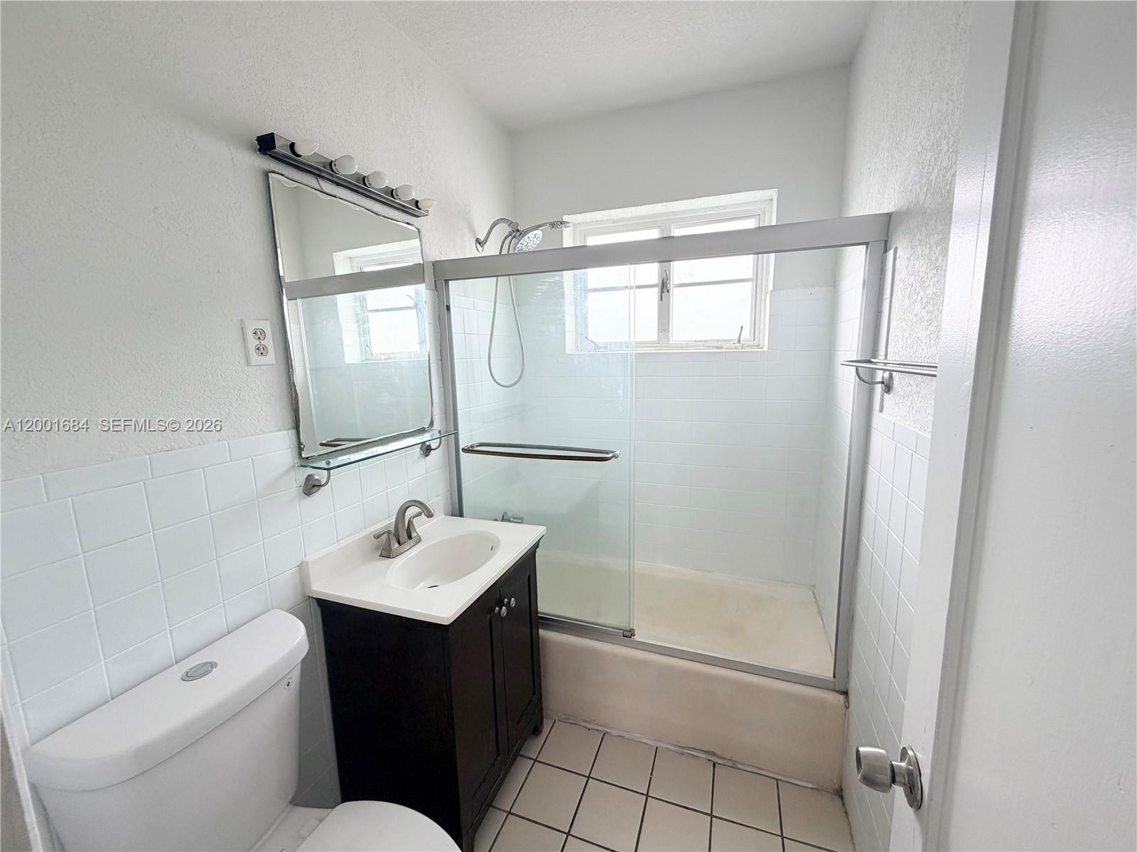 620 84th Street, Unit 25 Miami Beach, FL 33141 - Photo 5 of 12 a bathroom with a sink toilet and shower