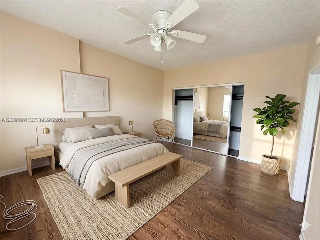620 84th Street, Unit 25 Miami Beach, FL 33141 - Photo 6 of 12 a spacious bedroom with a bed and a chandelier