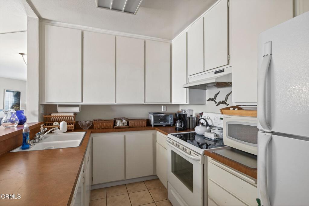 2901 Peninsula Road, Unit 333 Oxnard, CA 93035 - Photo 4 of 14 a kitchen with a sink stove and cabinets