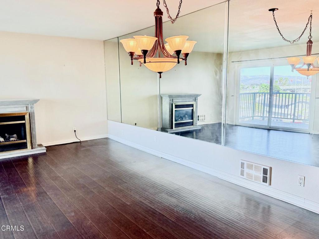 2901 Peninsula Road, Unit 333 Oxnard, CA 93035 - Photo 6 of 14 a view of an empty room with wooden floor and a window