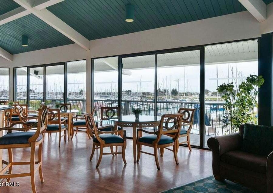 2901 Peninsula Road, Unit 333 Oxnard, CA 93035 - Photo 9 of 14 a living room with furniture and floor to ceiling windows