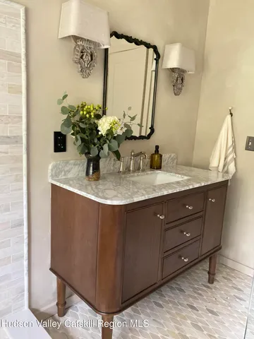 a bathroom with a sink a vanity and a mirror