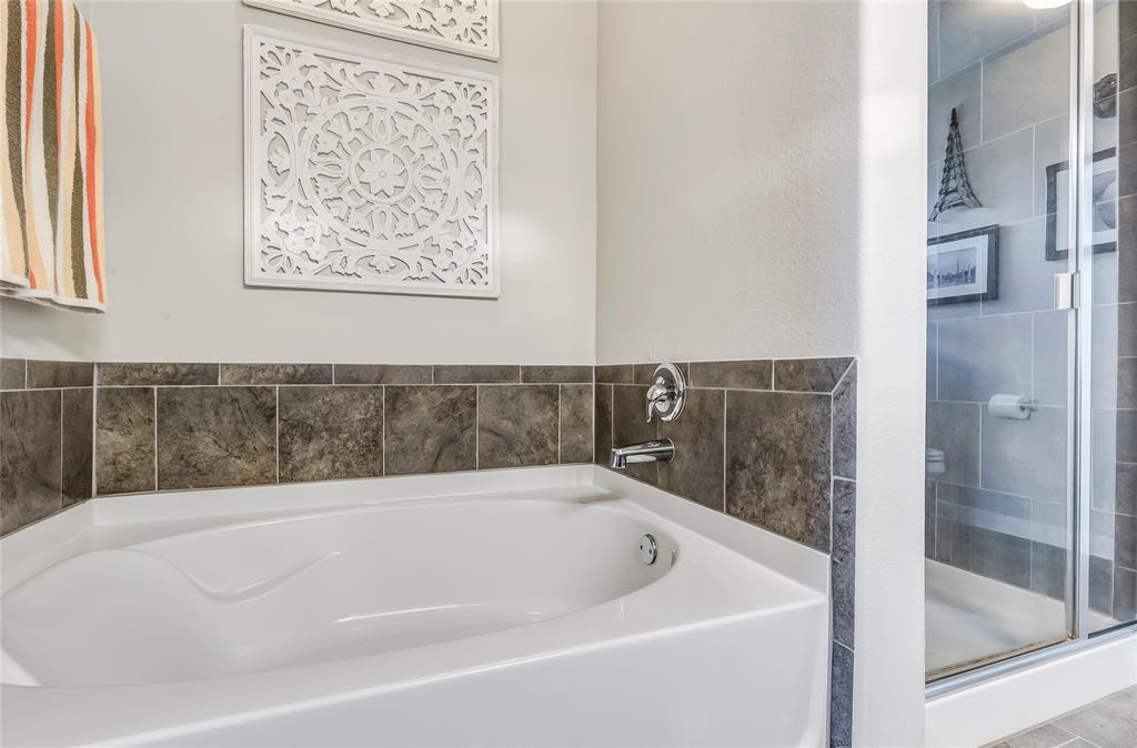 231 Windswept Way Kyle, TX 78640 - Photo 16 of 33 Bathroom with a garden tub and a shower stall