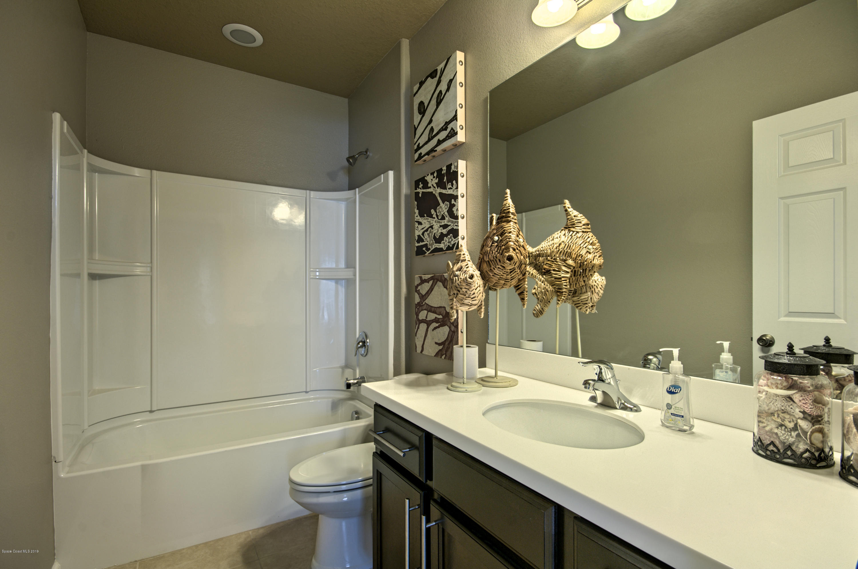 1027 Corbin Circle Southwest Palm Bay, FL 32908 - Photo 11 of 11 a bathroom with a sink a toilet and shower