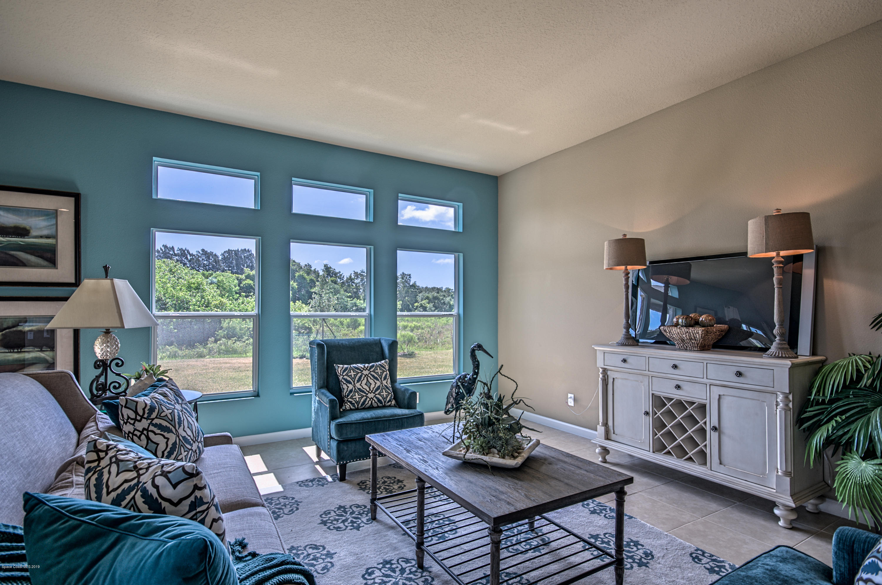 1027 Corbin Circle Southwest Palm Bay, FL 32908 - Photo 3 of 11 a living room with furniture and a flat screen tv