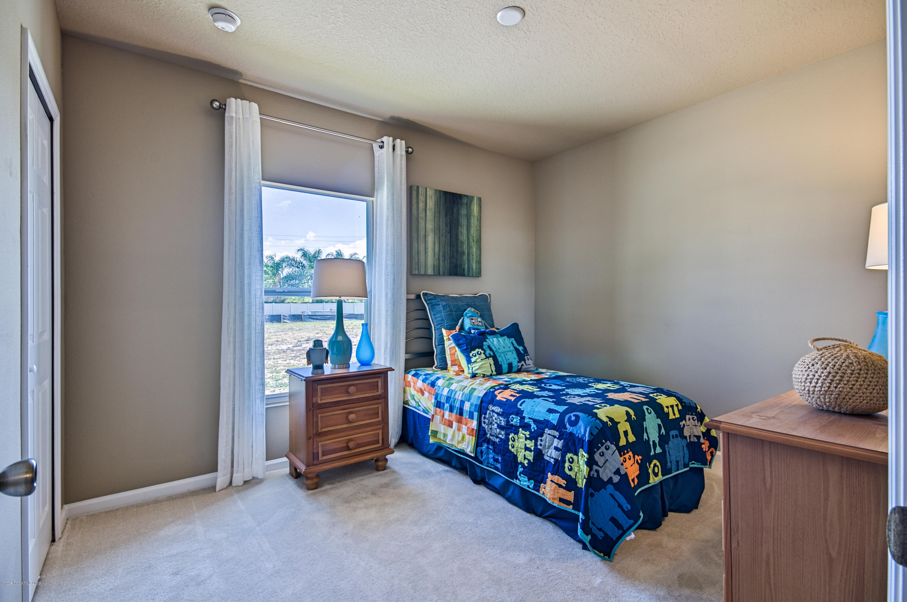 1027 Corbin Circle Southwest Palm Bay, FL 32908 - Photo 10 of 11 a bedroom with a bed and a window