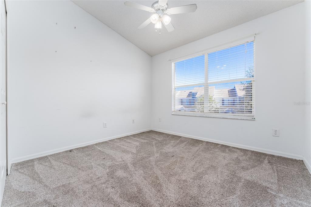 10423 Heron Lake Drive Riverview, FL 33578 - Photo 22 of 30 an empty room with a window and ceiling fan