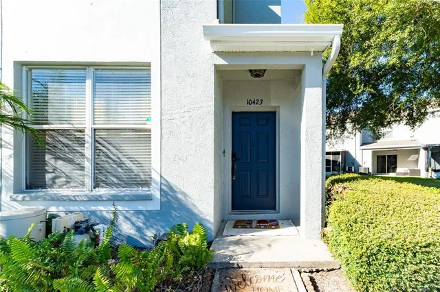 a view of house with backyard