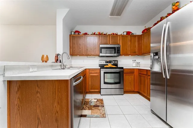 a kitchen with stainless steel appliances granite countertop a refrigerator stove and microwave