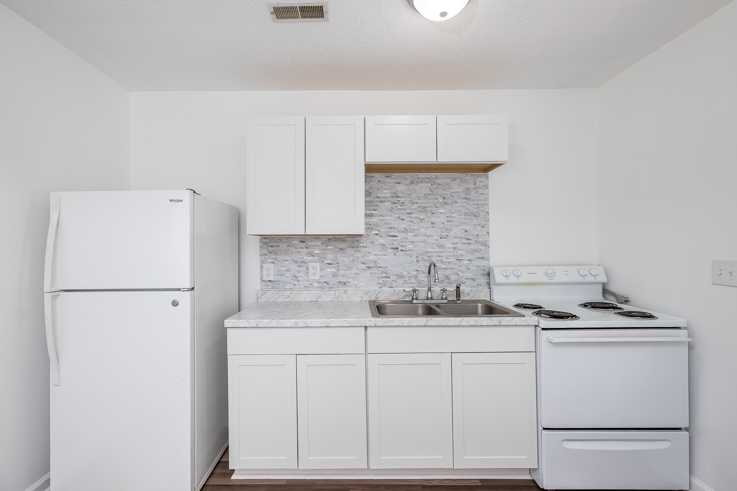 303 Burch Road Clarksville, TN 37042 - Photo 11 of 23 a white kitchen with sink refrigerator and cabinets
