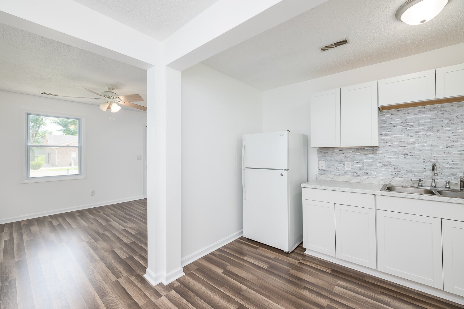 303 Burch Road Clarksville, TN 37042 - Photo 12 of 23 a view of a kitchen with wooden floor and electronic appliances