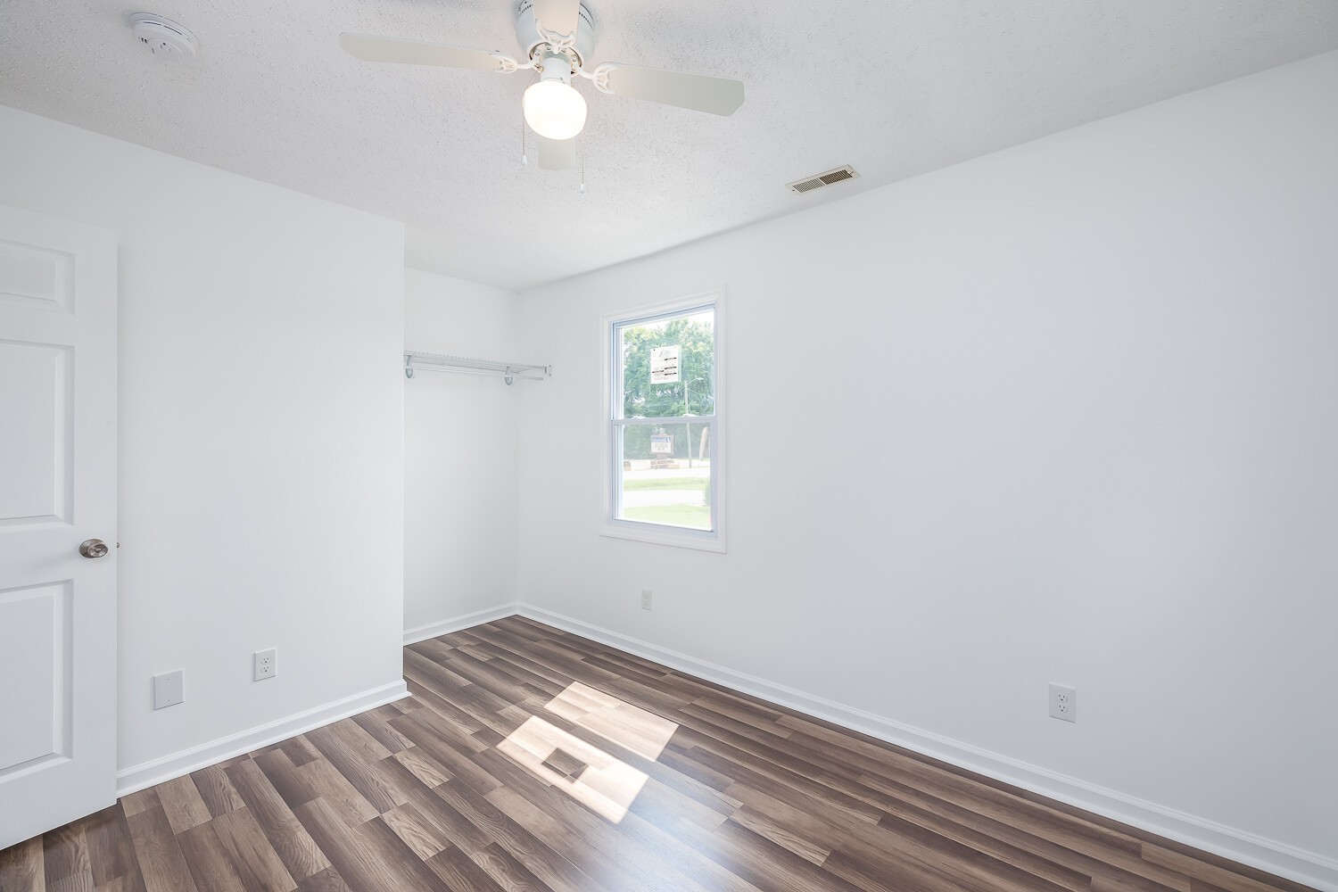 303 Burch Road Clarksville, TN 37042 - Photo 19 of 23 an empty room with wooden floor and windows