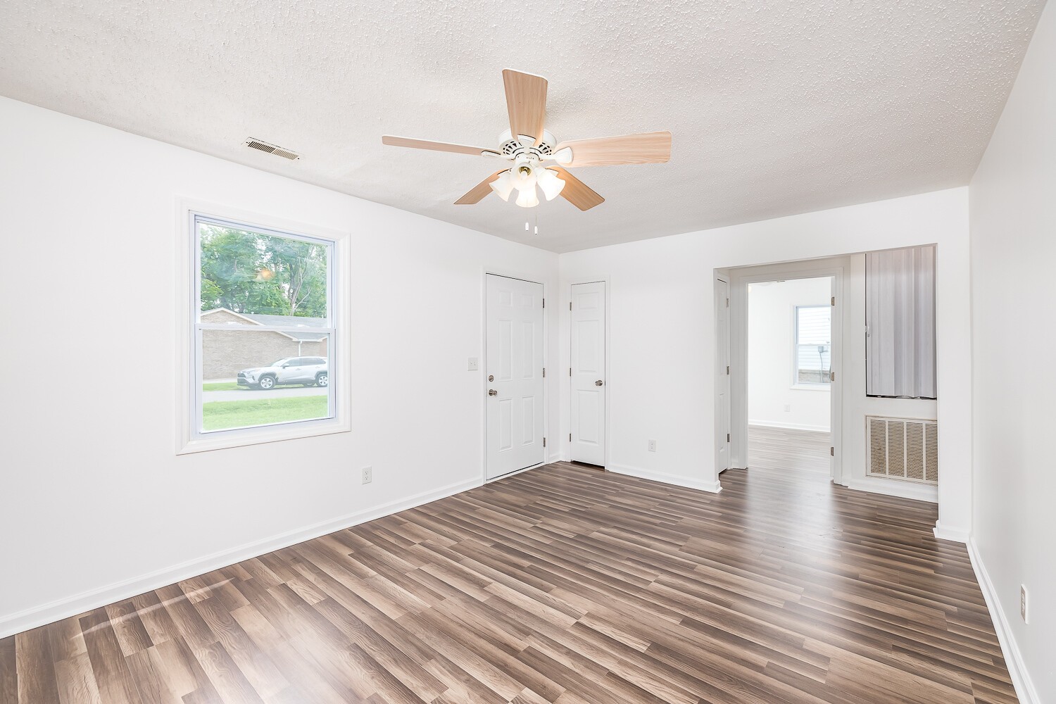 303 Burch Road Clarksville, TN 37042 - Photo 3 of 23 a view of an empty room with wooden floor and a window