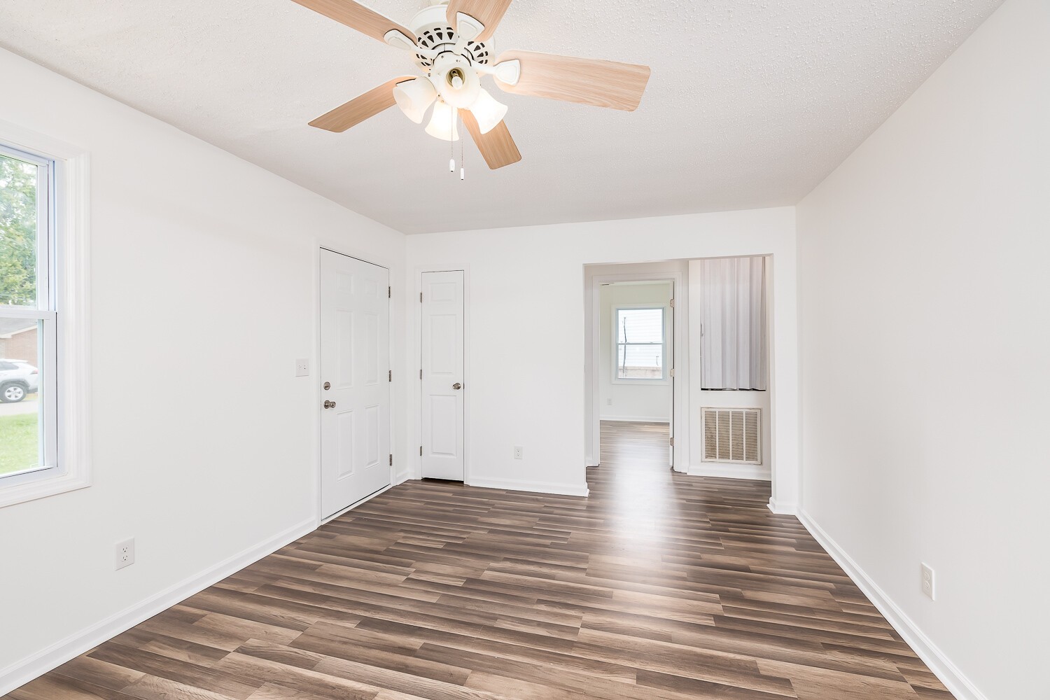 303 Burch Road Clarksville, TN 37042 - Photo 5 of 23 a view of an empty room with wooden floor and a window
