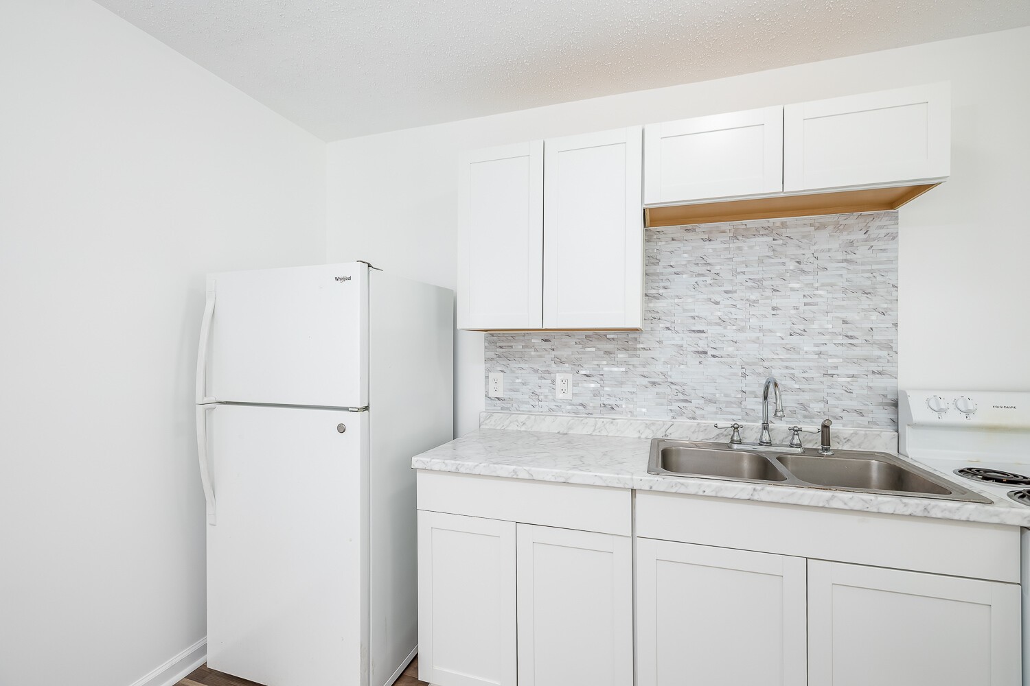 303 Burch Road Clarksville, TN 37042 - Photo 8 of 23 a kitchen with a sink a refrigerator and cabinets