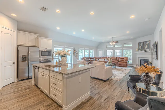 a kitchen with counter top space a sink appliances and cabinets