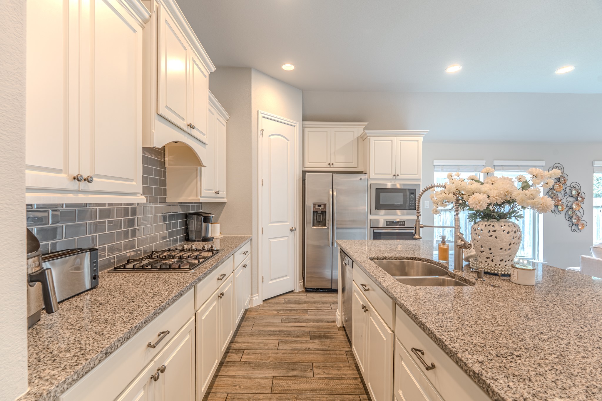 209 Trillium Park Loop Conroe, TX 77304 - Photo 13 of 50 a large kitchen with stainless steel appliances granite countertop a lot of counter space and wooden floors