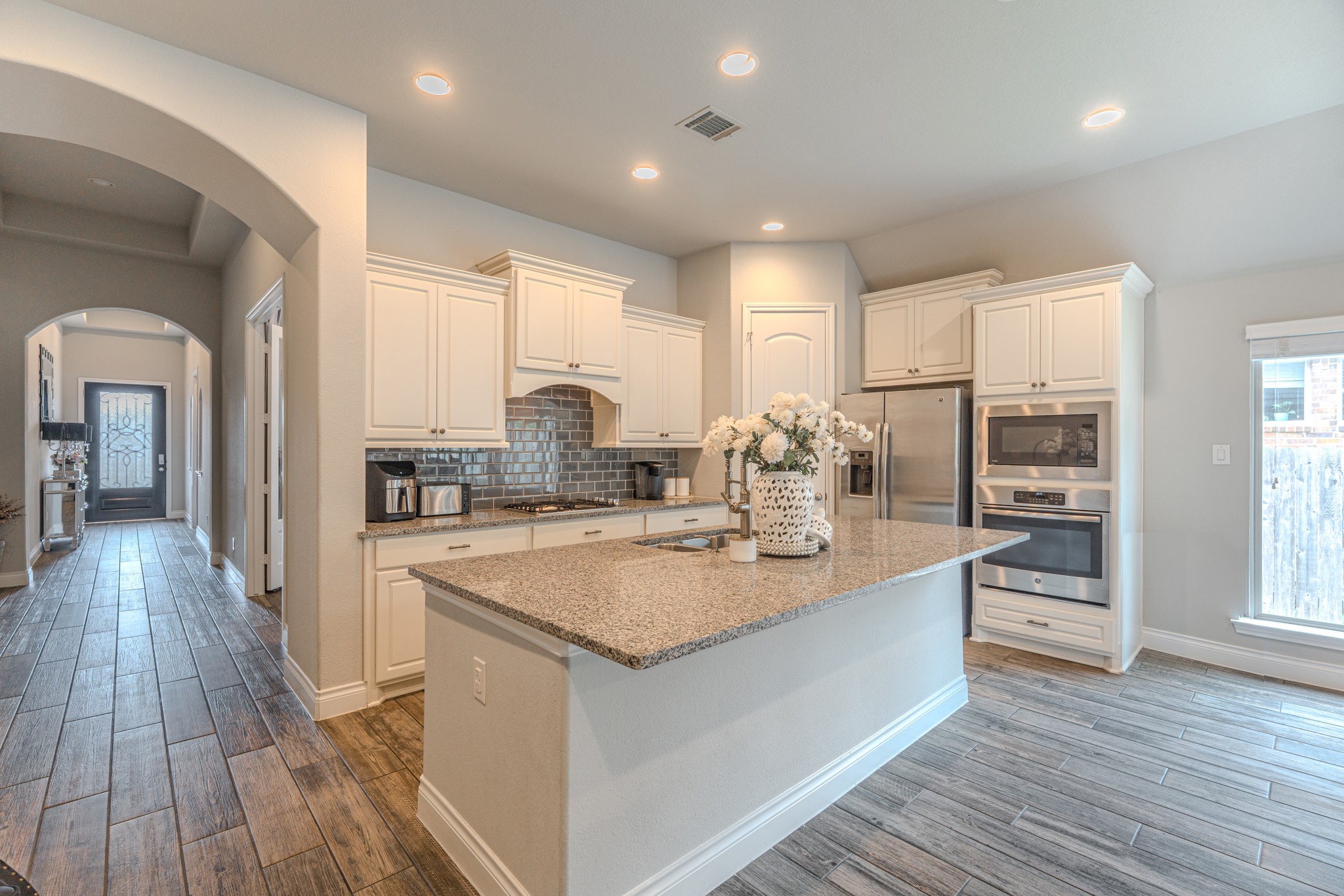 209 Trillium Park Loop Conroe, TX 77304 - Photo 14 of 50 a kitchen with sink stove and wooden floor