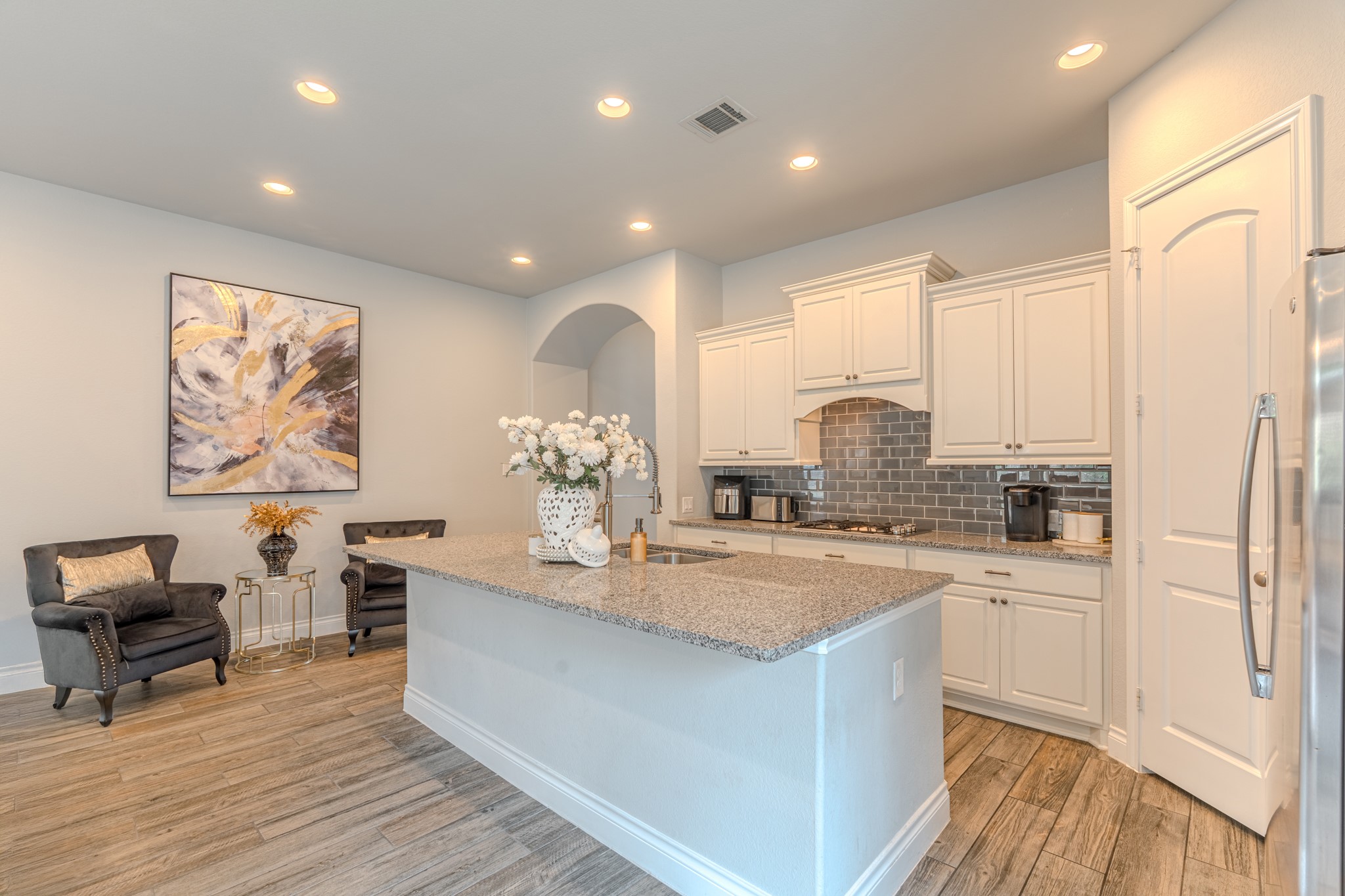 209 Trillium Park Loop Conroe, TX 77304 - Photo 16 of 50 a kitchen with stainless steel appliances granite countertop a sink cabinets and wooden floor