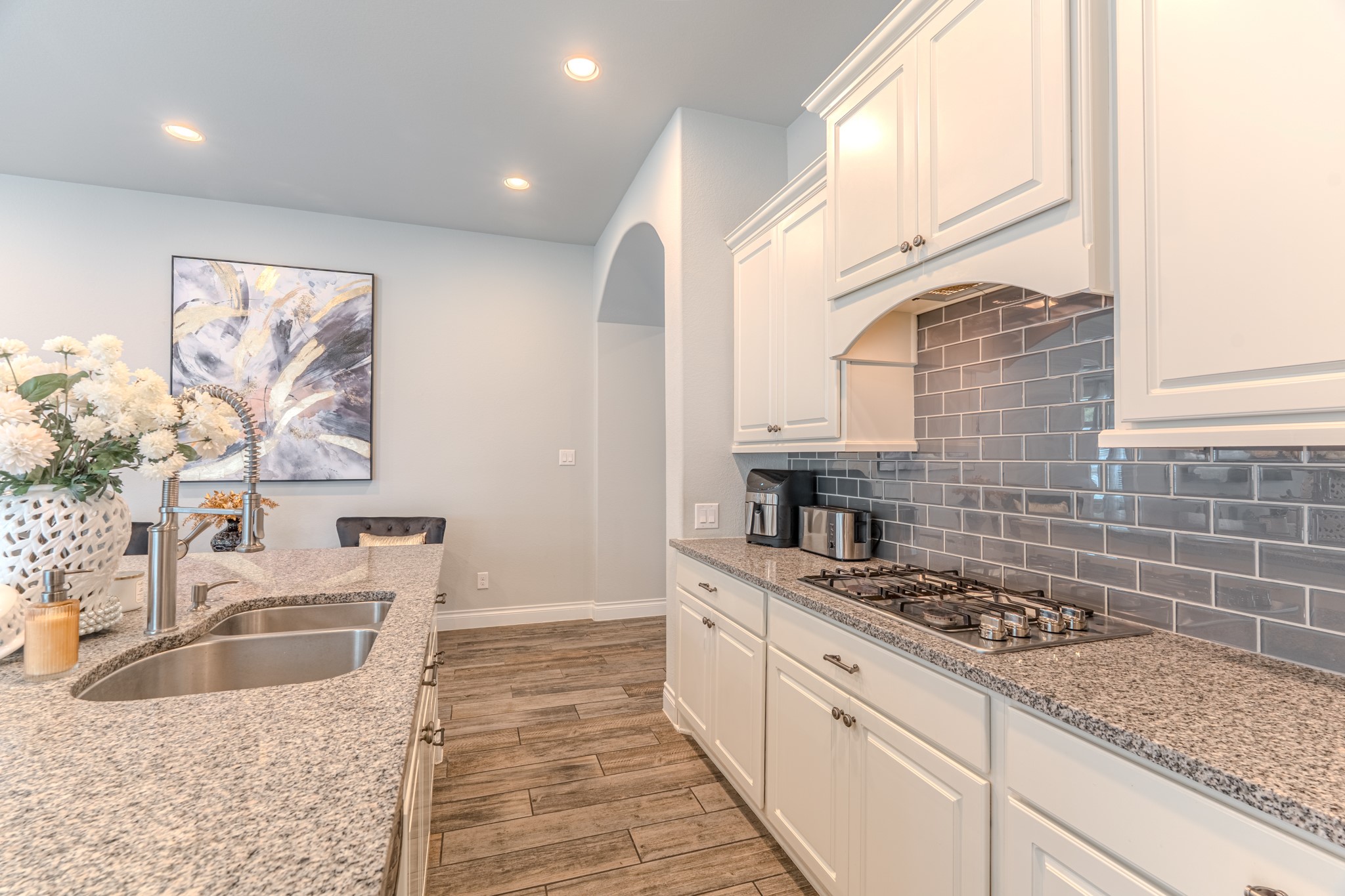 209 Trillium Park Loop Conroe, TX 77304 - Photo 17 of 50 a kitchen with stainless steel appliances kitchen island granite countertop a sink stove and cabinets