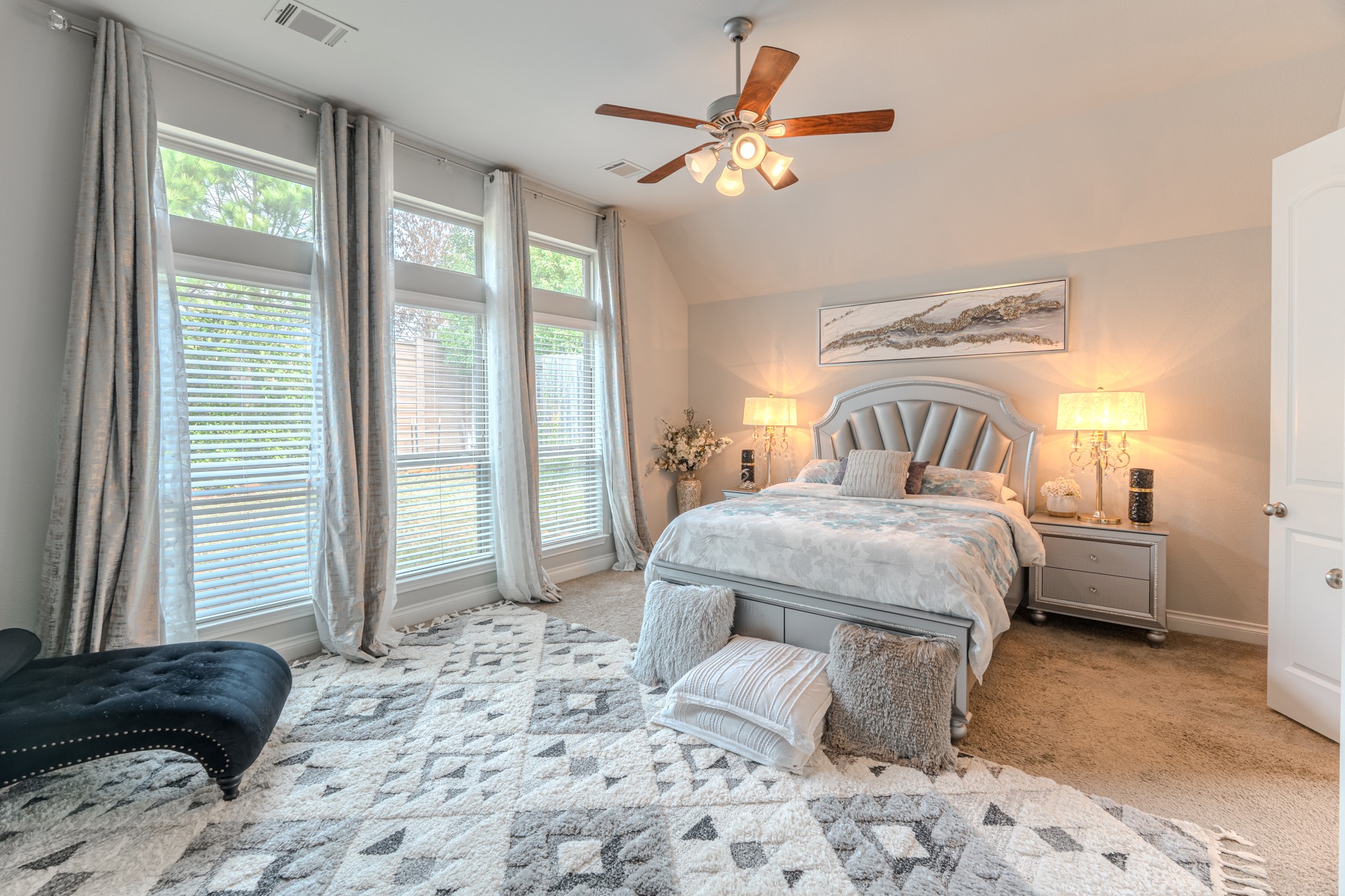209 Trillium Park Loop Conroe, TX 77304 - Photo 25 of 50 a bedroom with a bed a window and a chandelier
