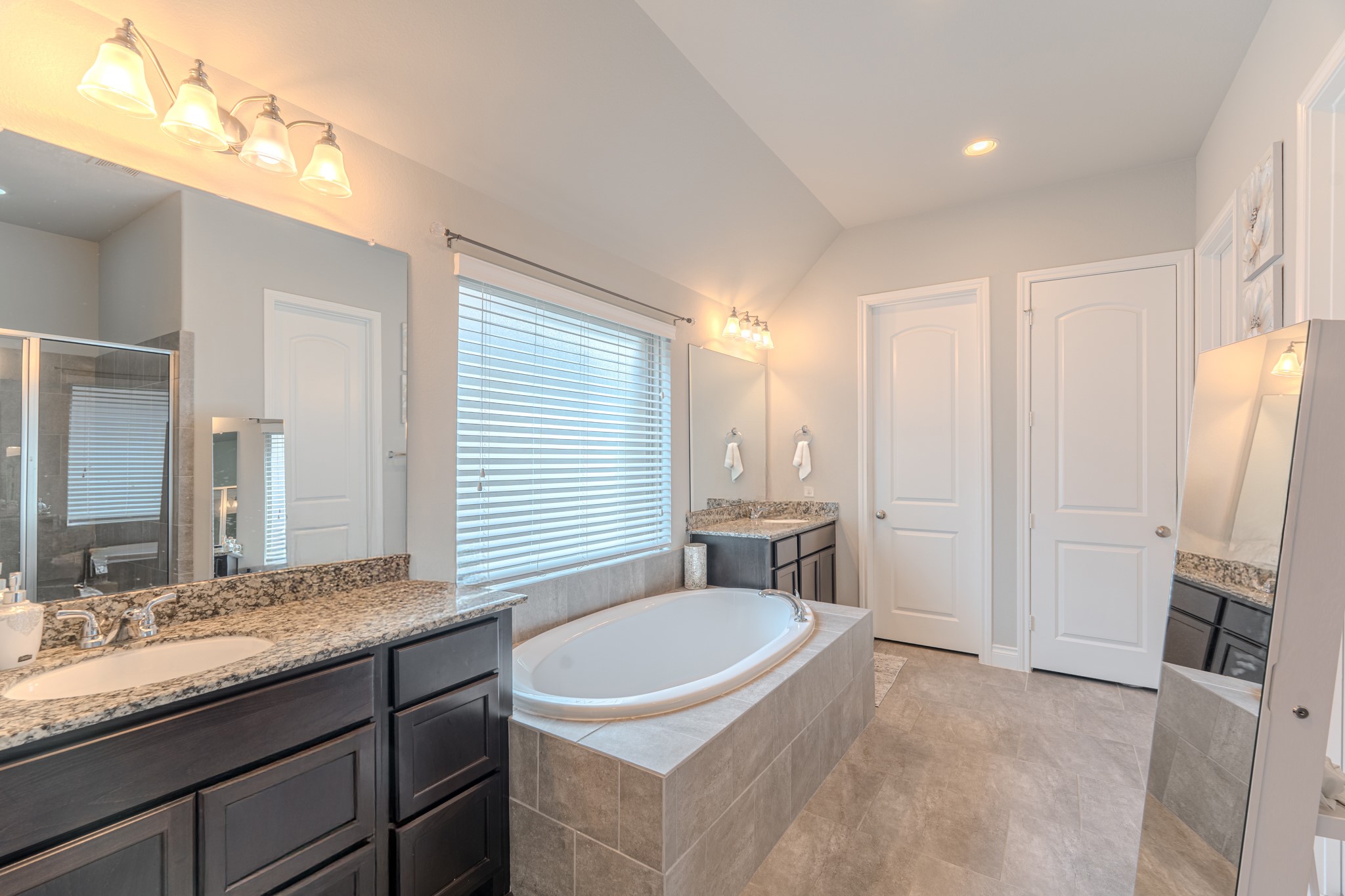 209 Trillium Park Loop Conroe, TX 77304 - Photo 28 of 50 a bathroom with a granite countertop sink and a mirror