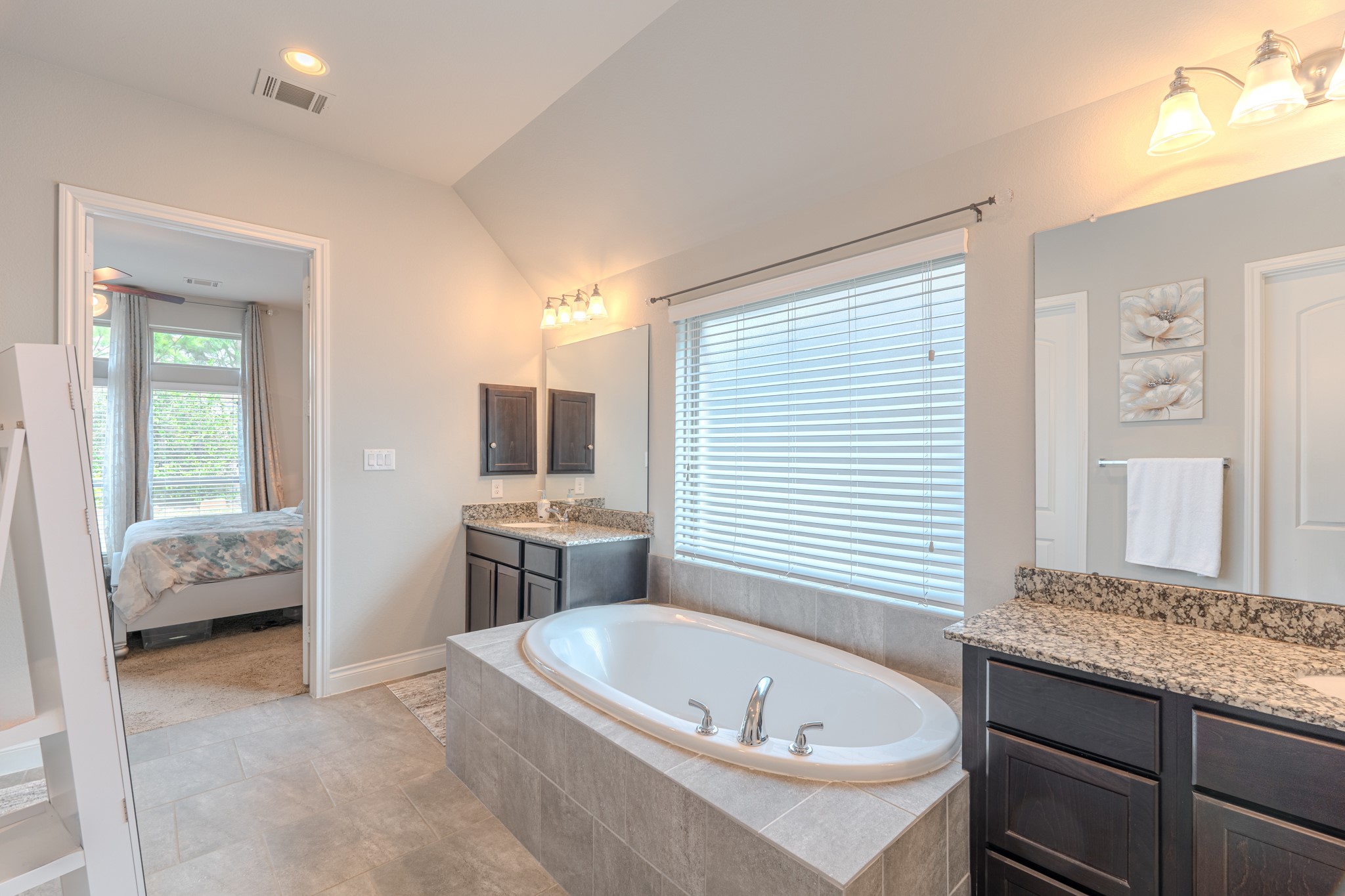 209 Trillium Park Loop Conroe, TX 77304 - Photo 29 of 50 a bathroom with a tub sink and mirror