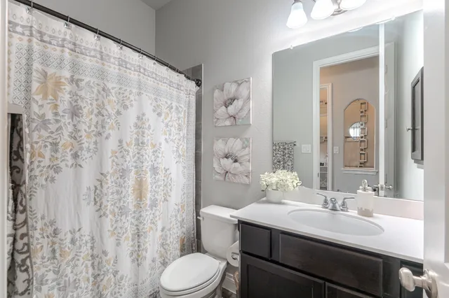 a bedroom with a bed and a mirror