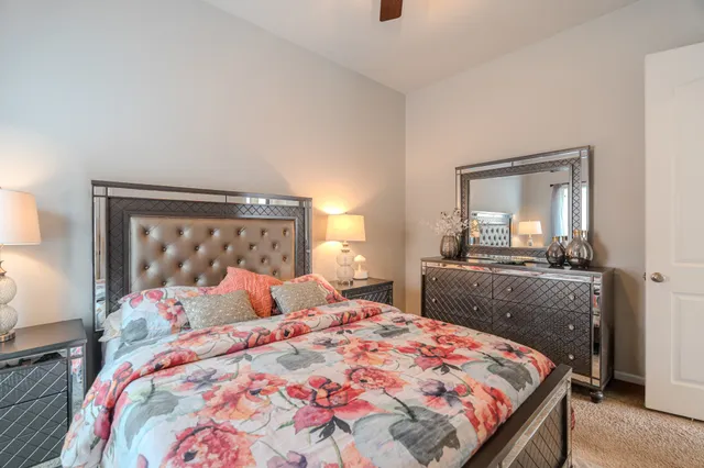 a bedroom with a bed and a chandelier