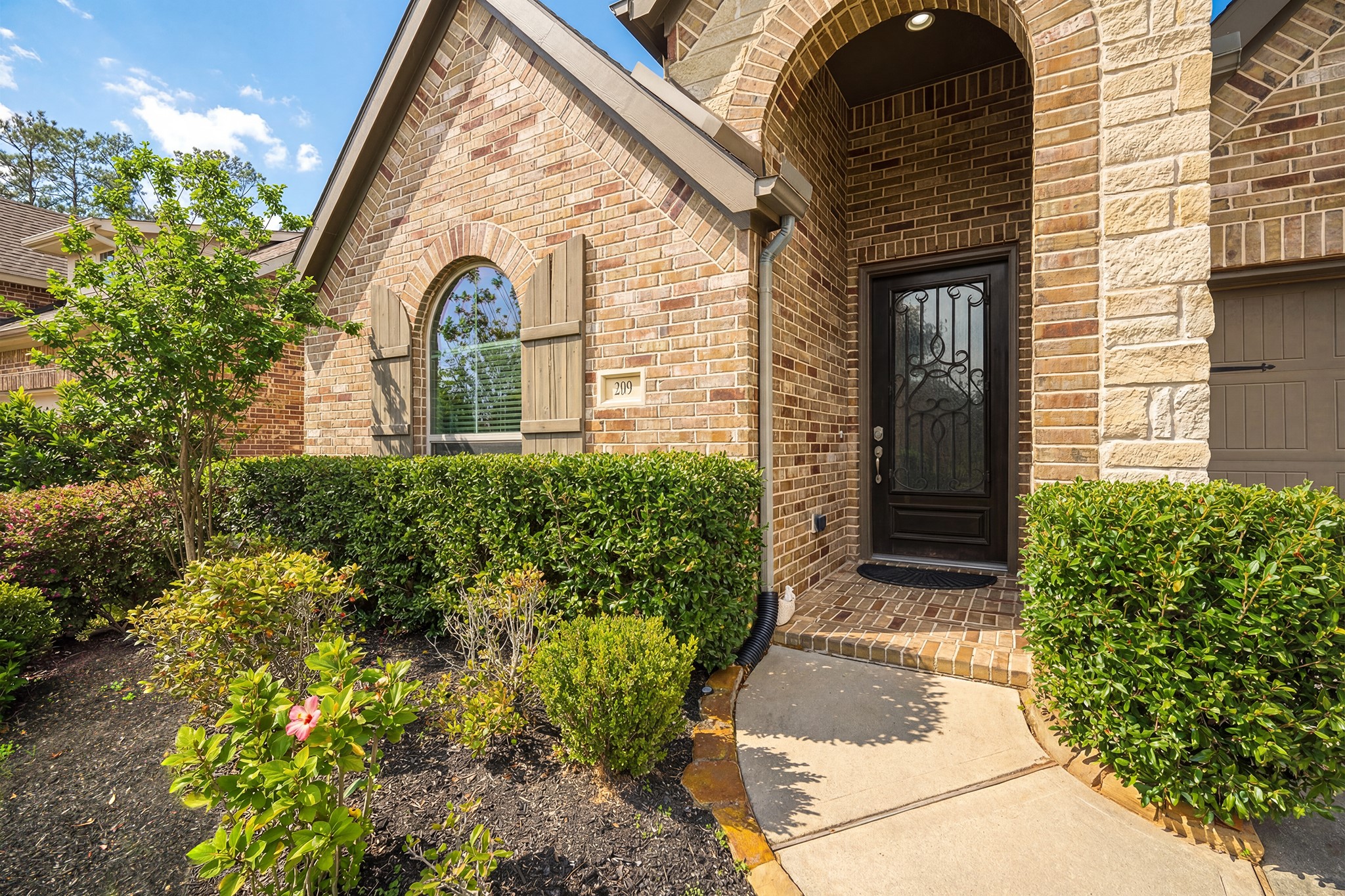 209 Trillium Park Loop Conroe, TX 77304 - Photo 6 of 50 a view of a brick house with potted plants