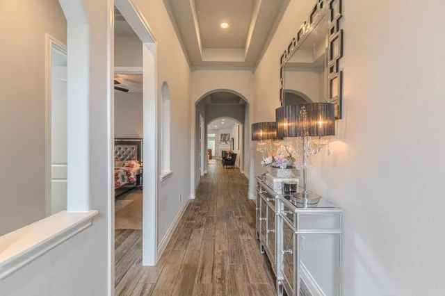 a view of a hallway with wooden floor and staircase