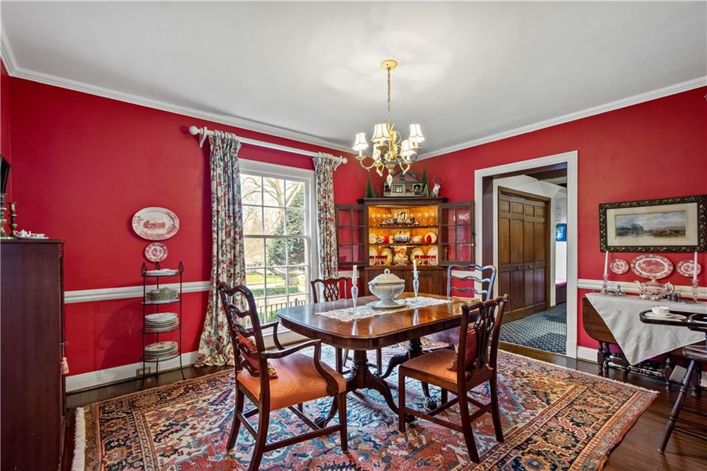 604 Poia Road Sewickley, PA 15143 - Photo 8 of 25 a view of a dining room with furniture a chandelier and wooden floor