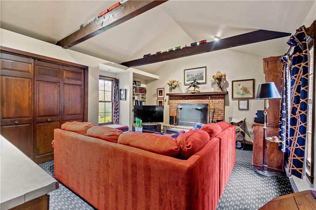604 Poia Road Sewickley, PA 15143 - Photo 10 of 25 a living room with fireplace furniture and a flat screen tv