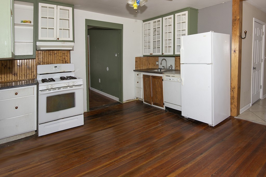 38-40 Beauregard Street Springfield, MA 01151 - Photo 8 of 30 a kitchen with a refrigerator stove and wooden cabinets