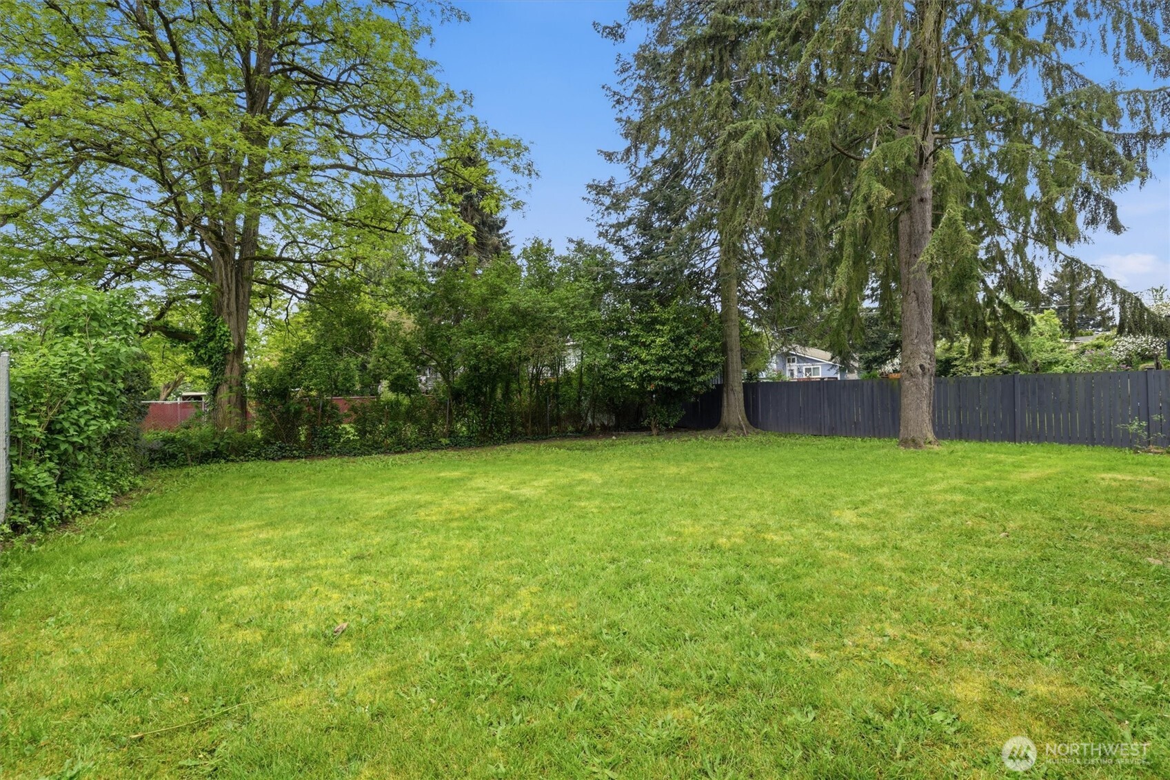 1651 Southwest 114th Street Seattle, WA 98146 - Photo 28 of 37 a backyard of a house with lots of green space