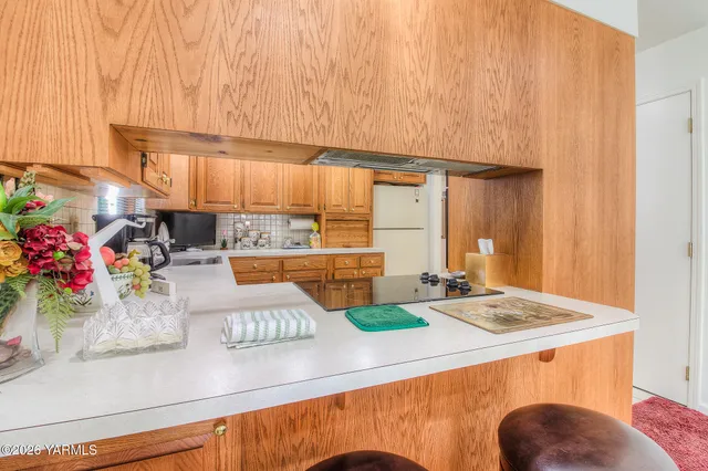 a kitchen with kitchen island granite countertop lots of clutter and stainless steel appliances