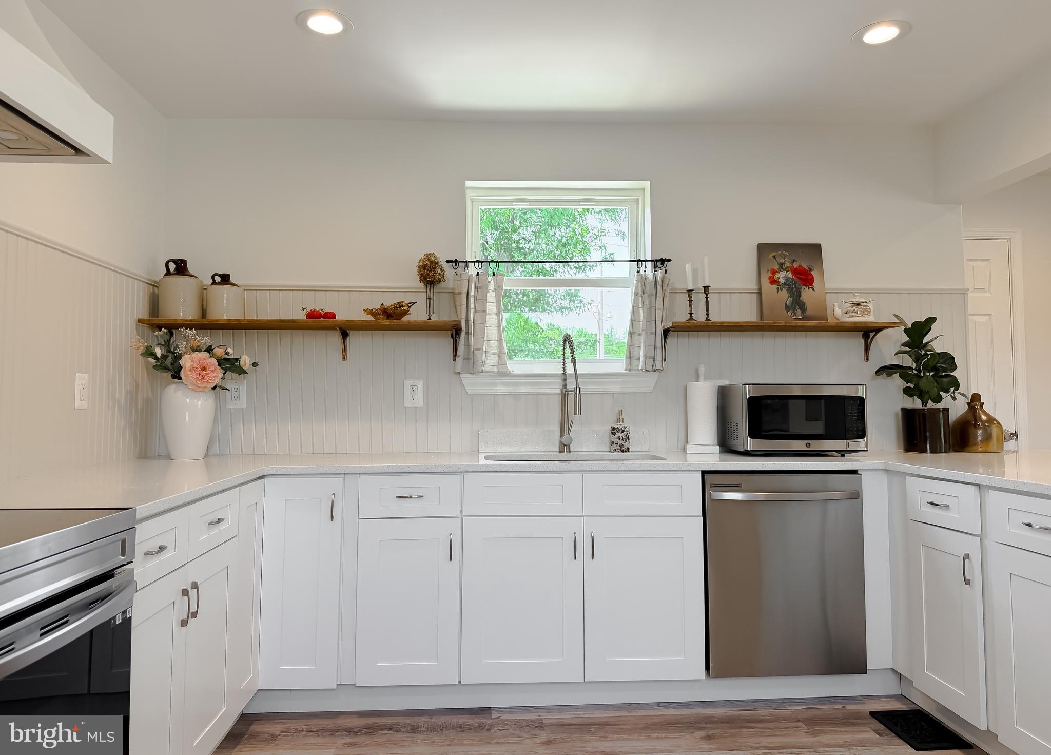4985 Solomons Island Road Huntingtown, MD 20639 - Photo 8 of 50 a kitchen with white cabinets and window
