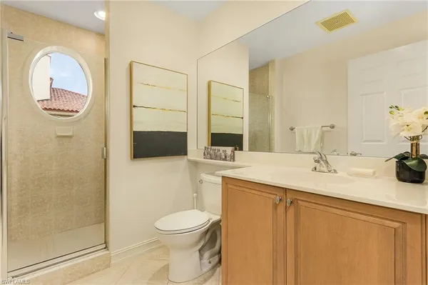 a bathroom with a toilet a sink and mirror
