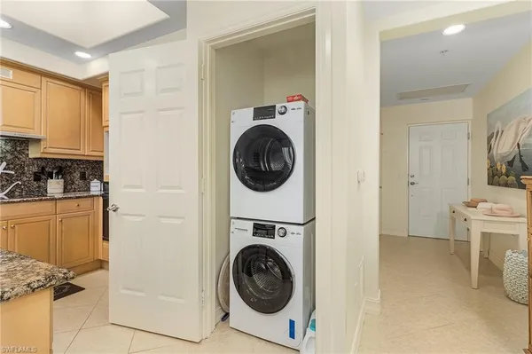 a utility room with sink dryer and washer