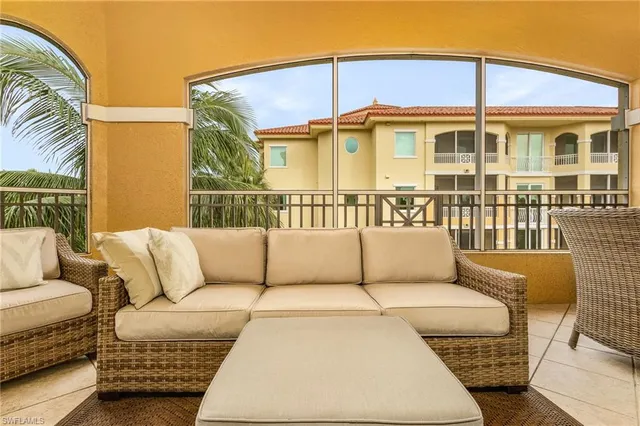 a view of a patio with couches chairs and wooden floor