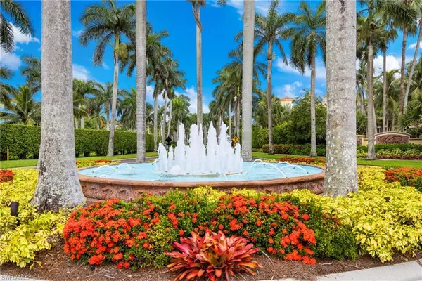a view of a fountain in front of a house