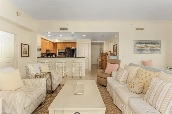 a living room with furniture and kitchen view