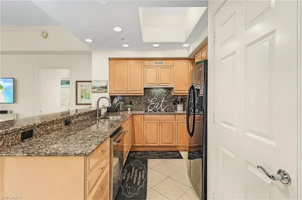 a view of a kitchen with a sink and cabinets