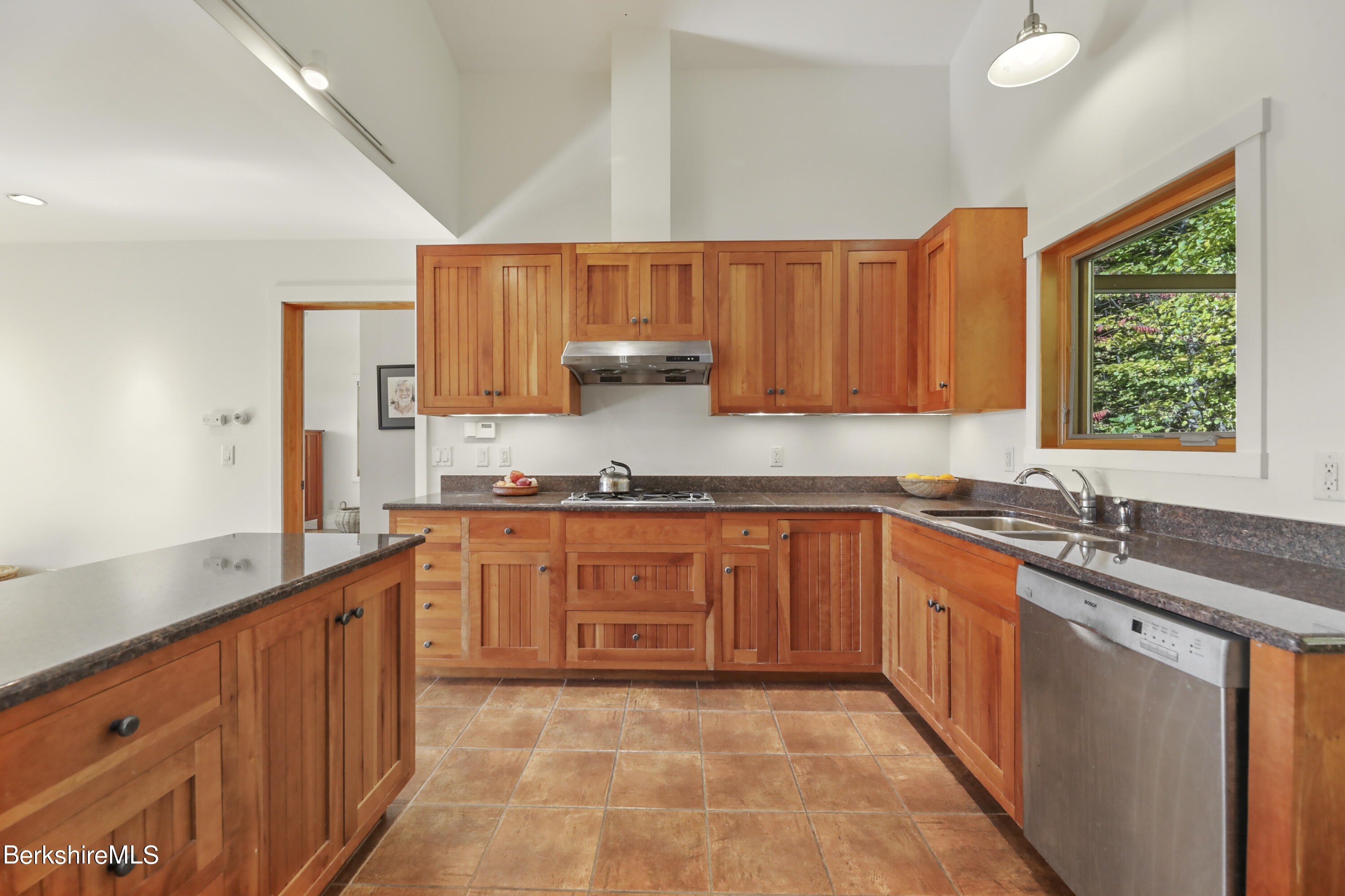 494 Dean Hill Road Richmond, MA 01254 - Photo 21 of 54 a kitchen with stainless steel appliances granite countertop a sink stove and cabinets