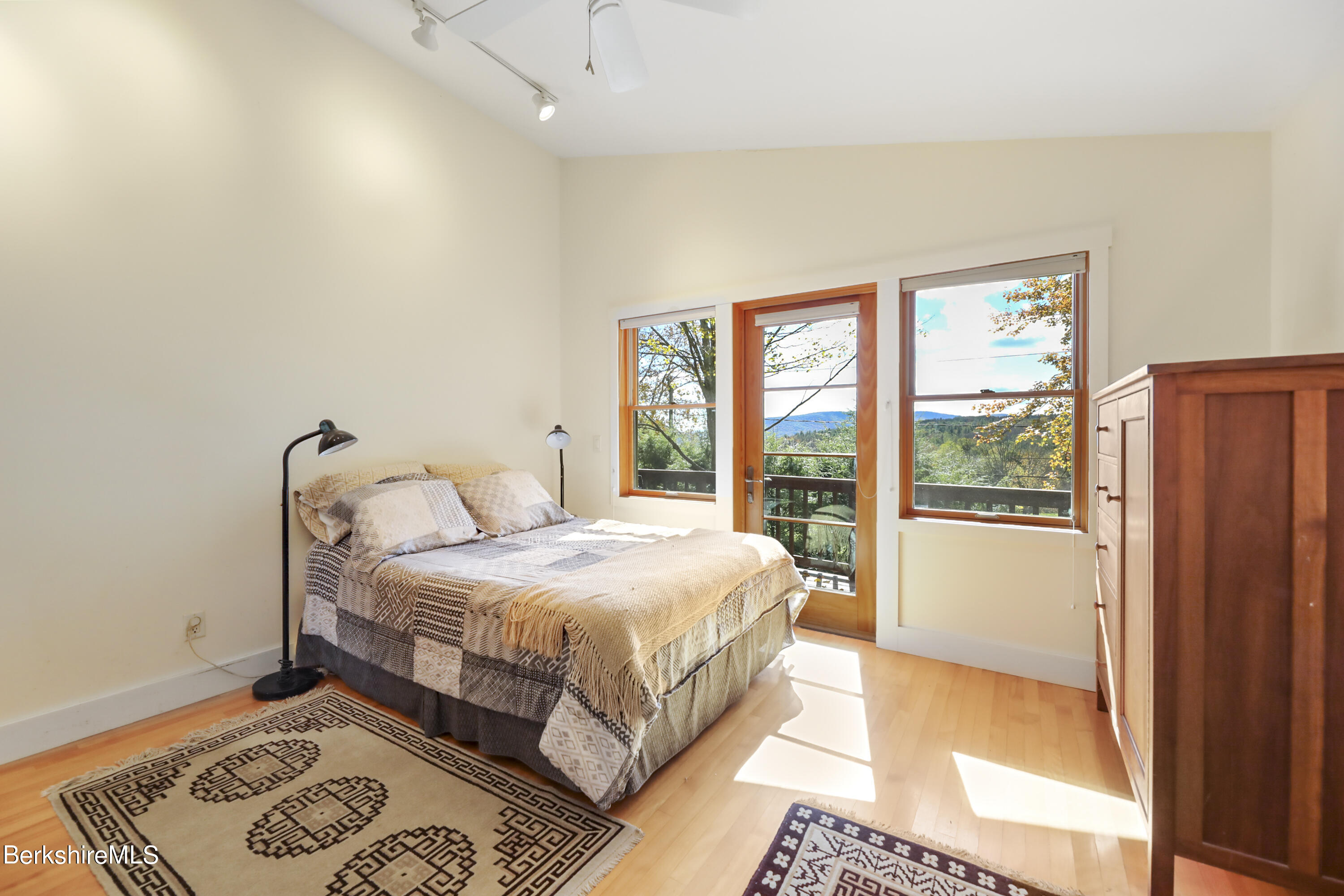 494 Dean Hill Road Richmond, MA 01254 - Photo 27 of 54 a bedroom with a bed lamp and a large window